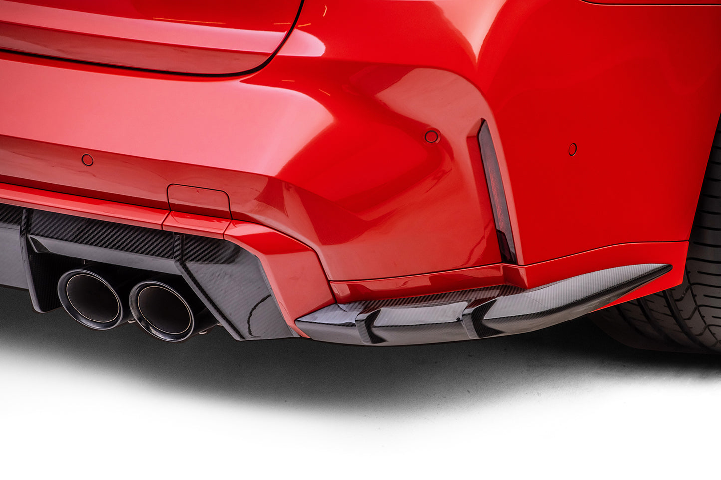 back of red car with black diffuser on white background