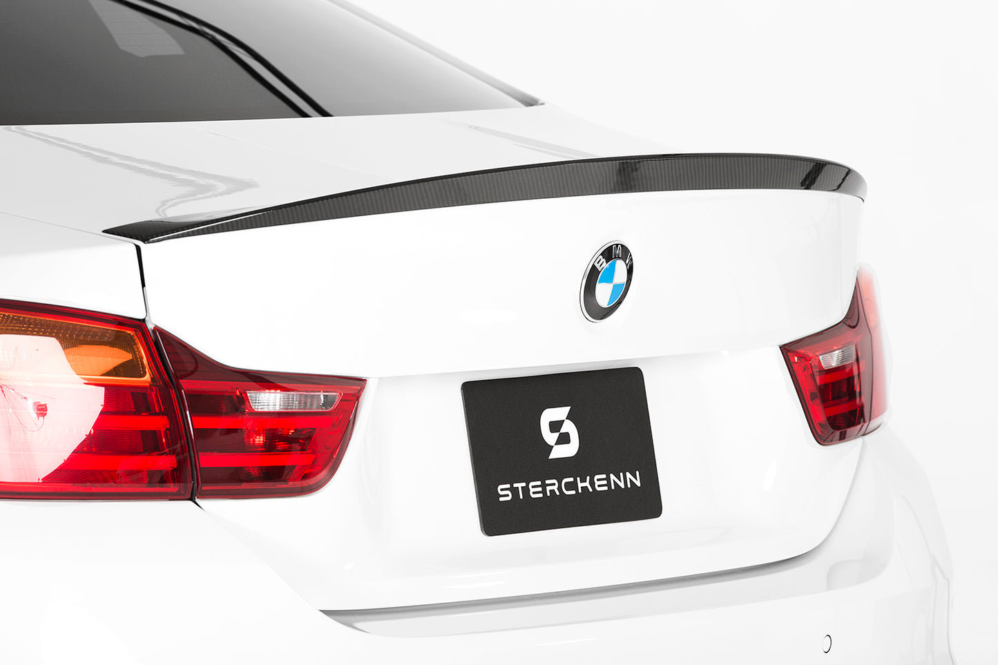 rear view of white bmw M4 with sterckenn logo