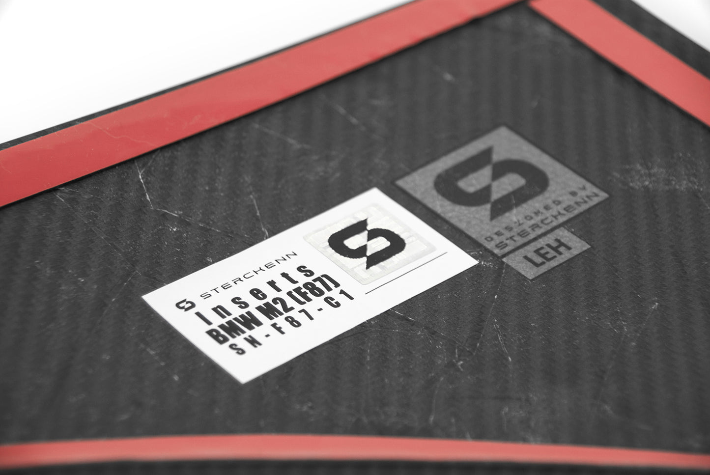 white sticker with Sterckenn logo on a dark background