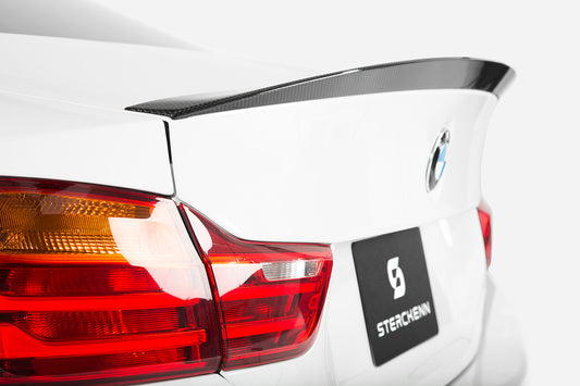 black spoiler on white bmw with sterckenn logo