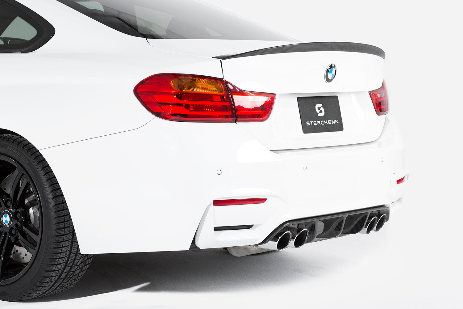 Rear bumper of a white BMW on a white background