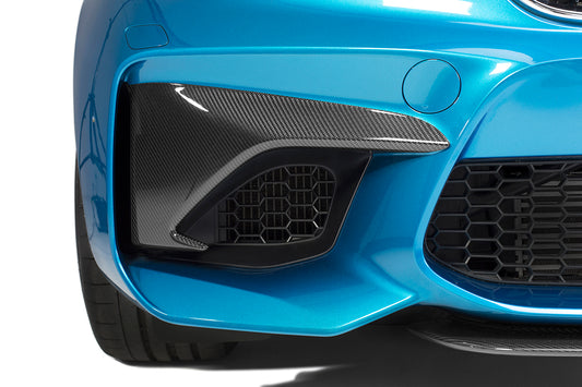 The bumper of a blue bmw M2 (F87) with the black bumper inserts