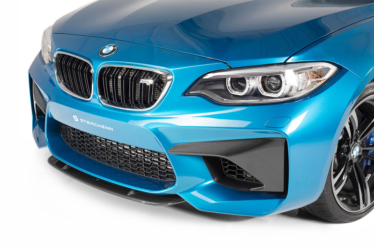 Side view of black splitter on BMW M2 (F87)with white background
