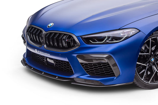 The bumper of a blue BMW M8 (F92) on a white background