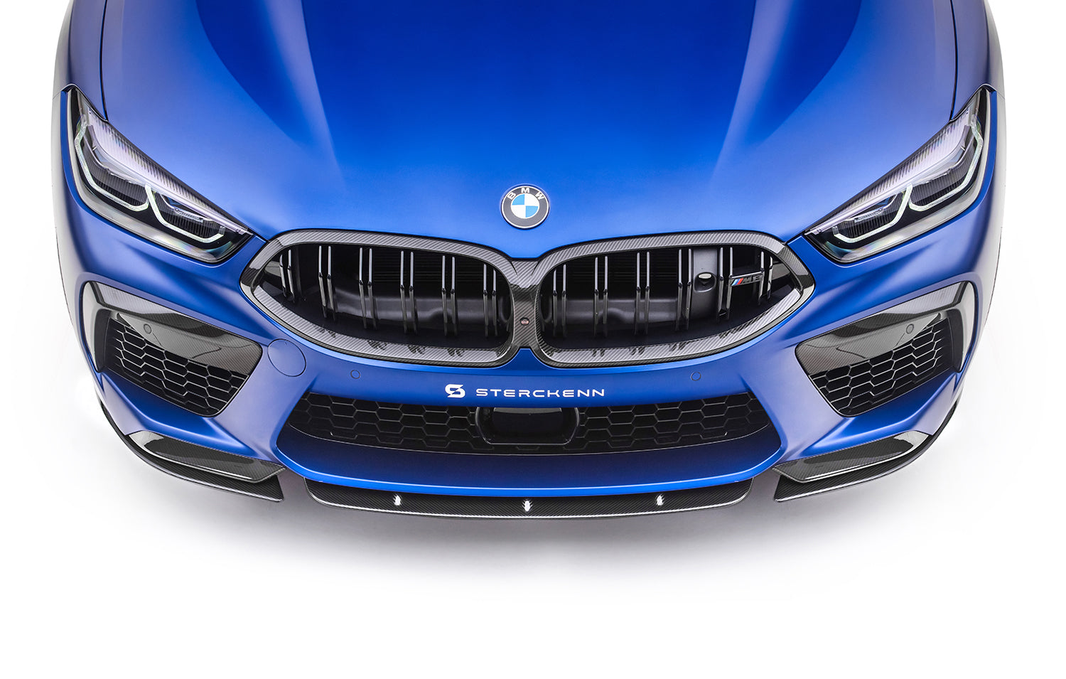 front view of the front bumper of a blue BMW M8 (F92) with the sterckenn logo
