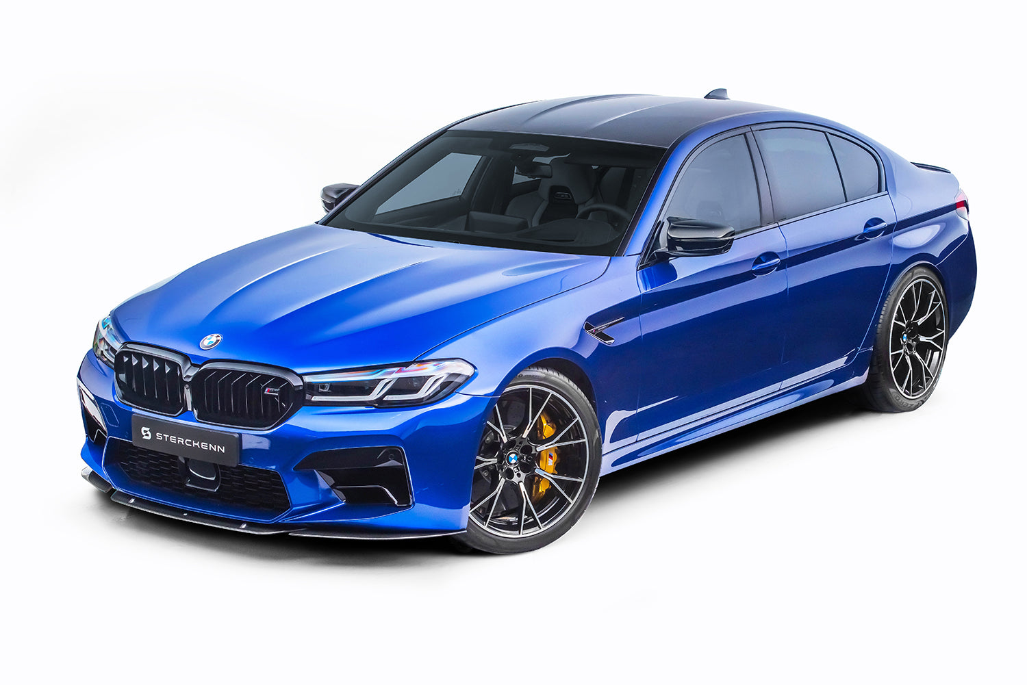 Side view of the blue BMW M5 (F90) LCI on a white background