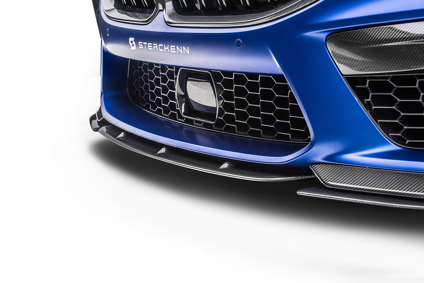 Close-up of splitter put on blue BMW M8 (F92) on white background