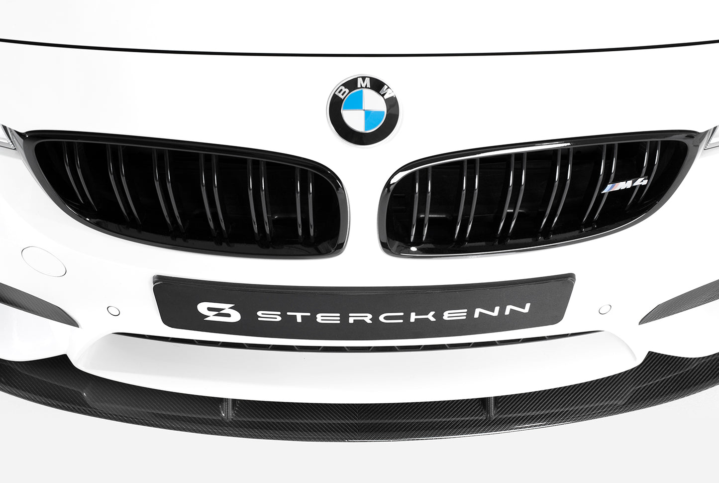 front view of white bmw with sterckenn logo