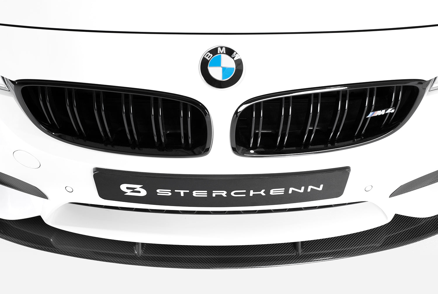 front view of white bmw with sterckenn logo