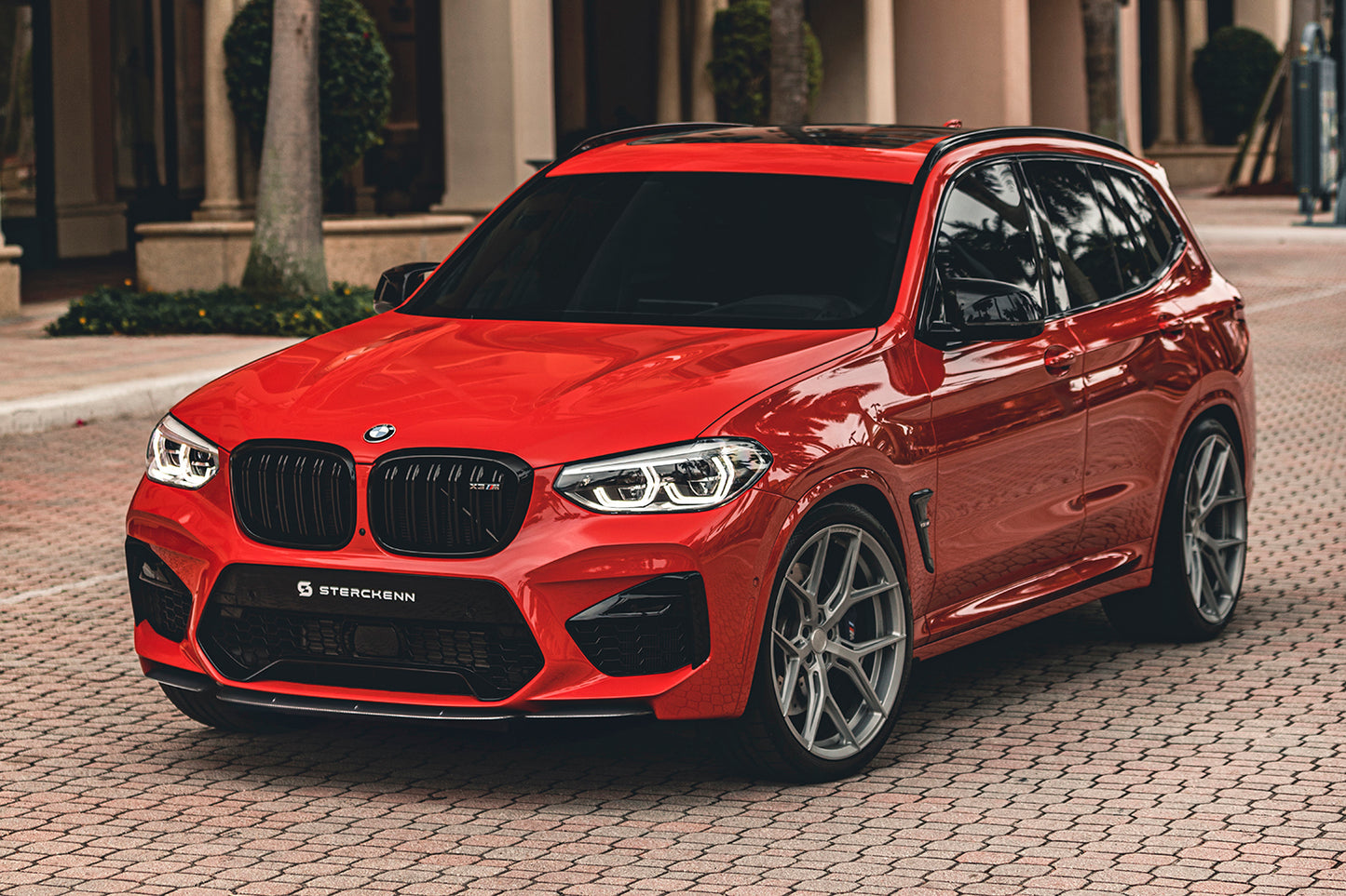 red BMW X3M (F97) on the street background