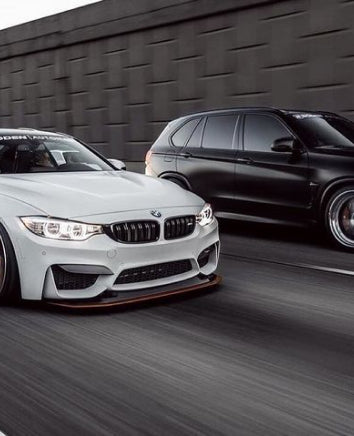 black and white bmw driving down the road